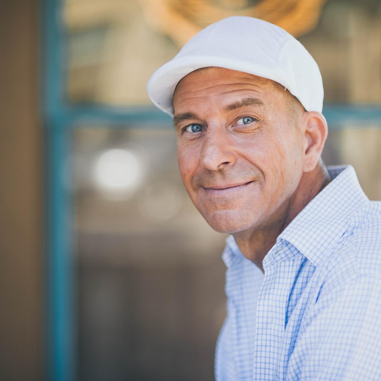 man smiling while sitting